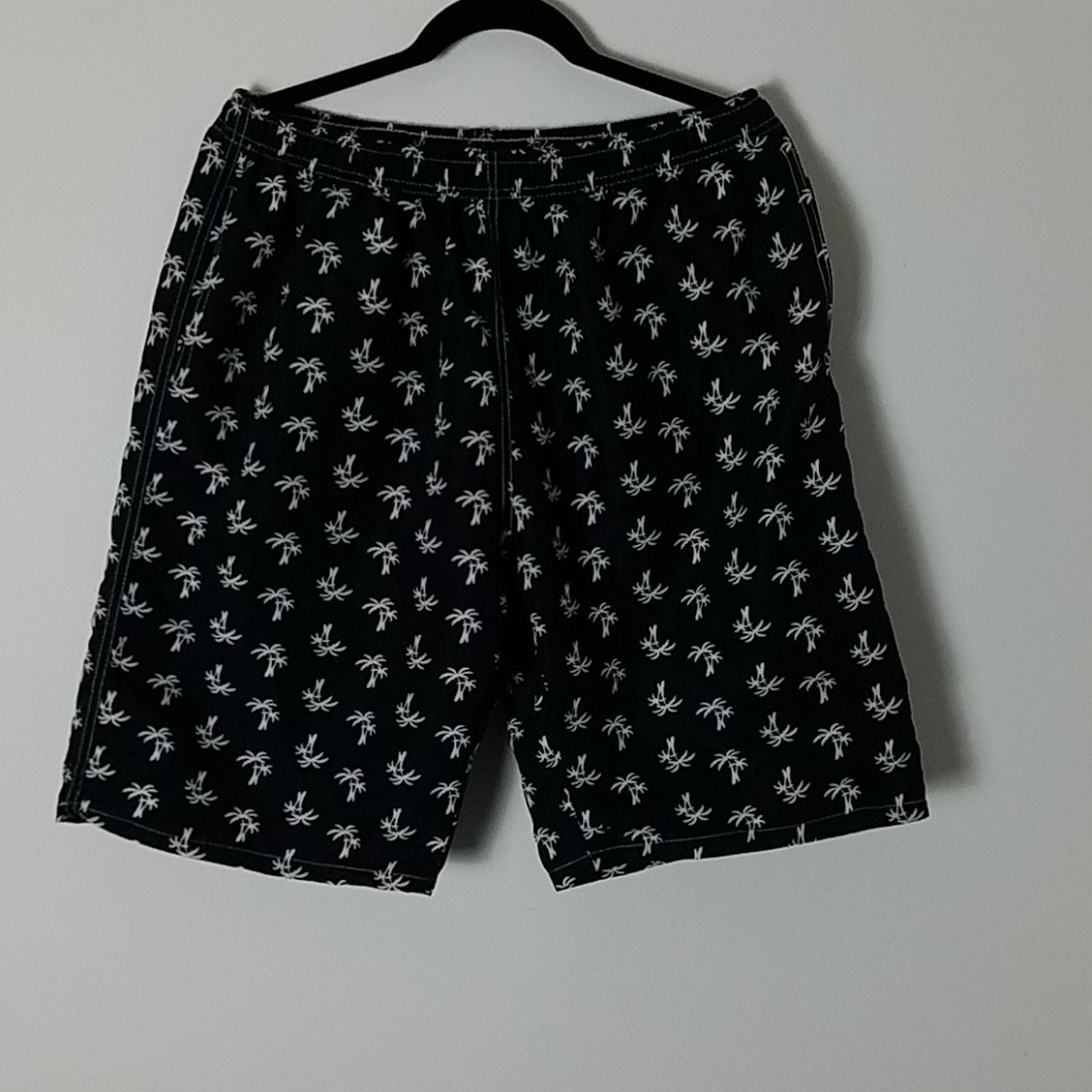 Black swim trunks palm trees. Pockets drawstring